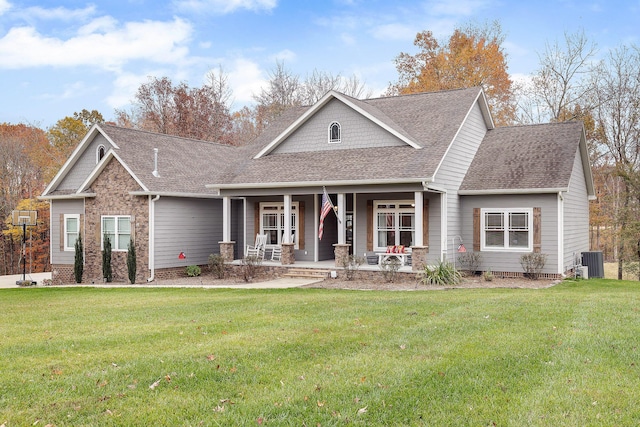 craftsman-style home with cooling unit, covered porch, and a front yard