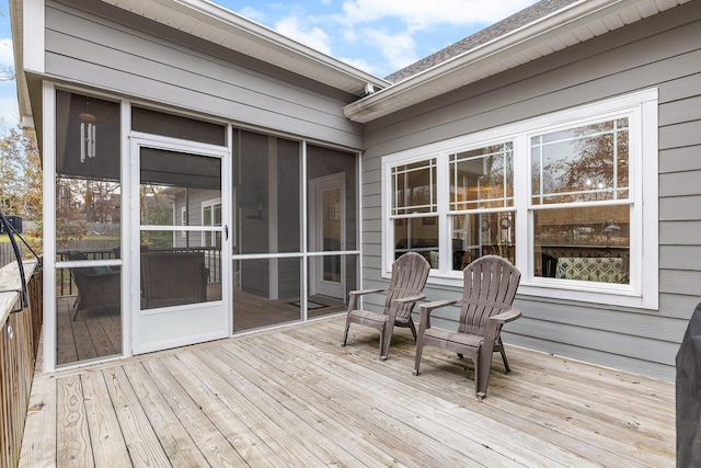 wooden deck with a sunroom