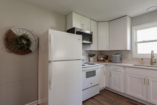 kitchen with white appliances, white cabinets, sink, decorative backsplash, and dark hardwood / wood-style flooring