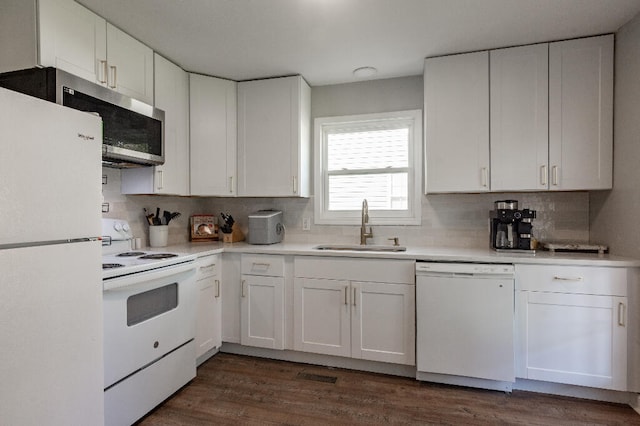 kitchen featuring tasteful backsplash, sink, white cabinets, and white appliances