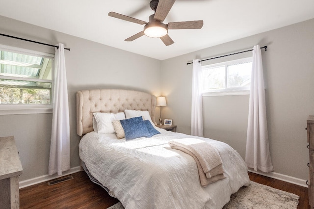 bedroom with ceiling fan and dark wood-type flooring