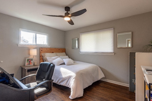 bedroom with dark hardwood / wood-style flooring and ceiling fan