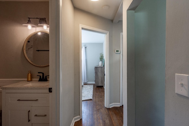 hall with dark hardwood / wood-style flooring and sink