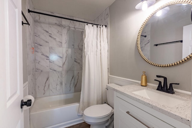 full bathroom featuring shower / bath combo, vanity, and toilet