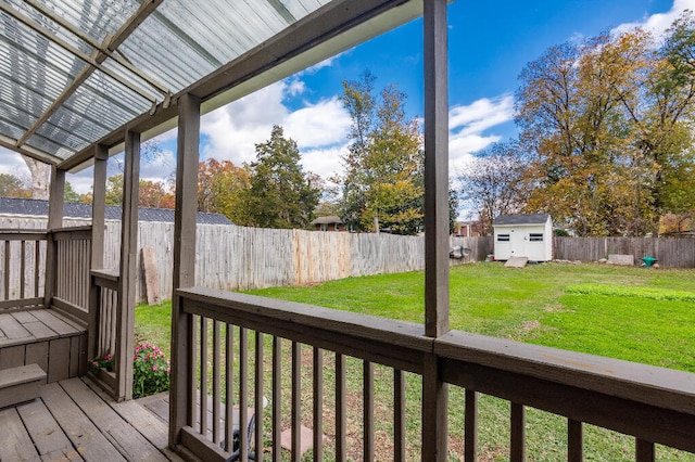 deck with a yard and a shed