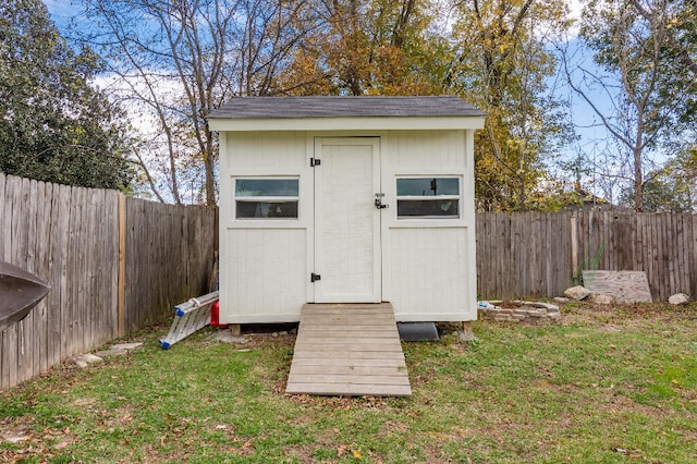 view of outdoor structure featuring a lawn