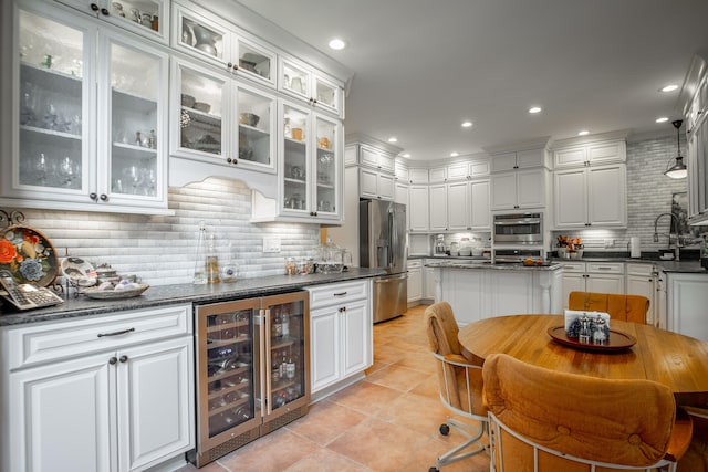 kitchen with white cabinetry, beverage cooler, stainless steel refrigerator with ice dispenser, backsplash, and dark stone countertops