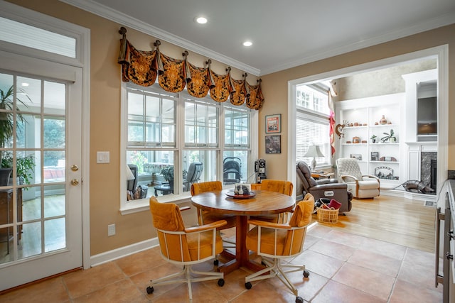 tiled dining area featuring built in features and ornamental molding