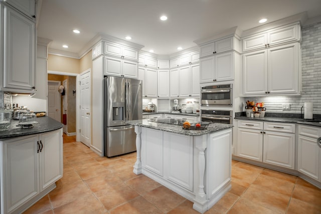 kitchen with a kitchen island, white cabinetry, and stainless steel appliances