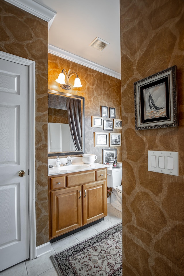 bathroom featuring tile patterned flooring, vanity, and crown molding