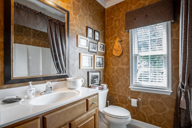 bathroom with vanity, toilet, and crown molding