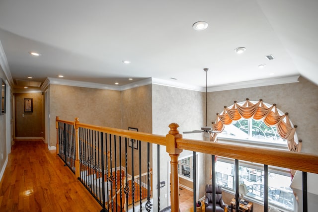 hall with hardwood / wood-style flooring and ornamental molding