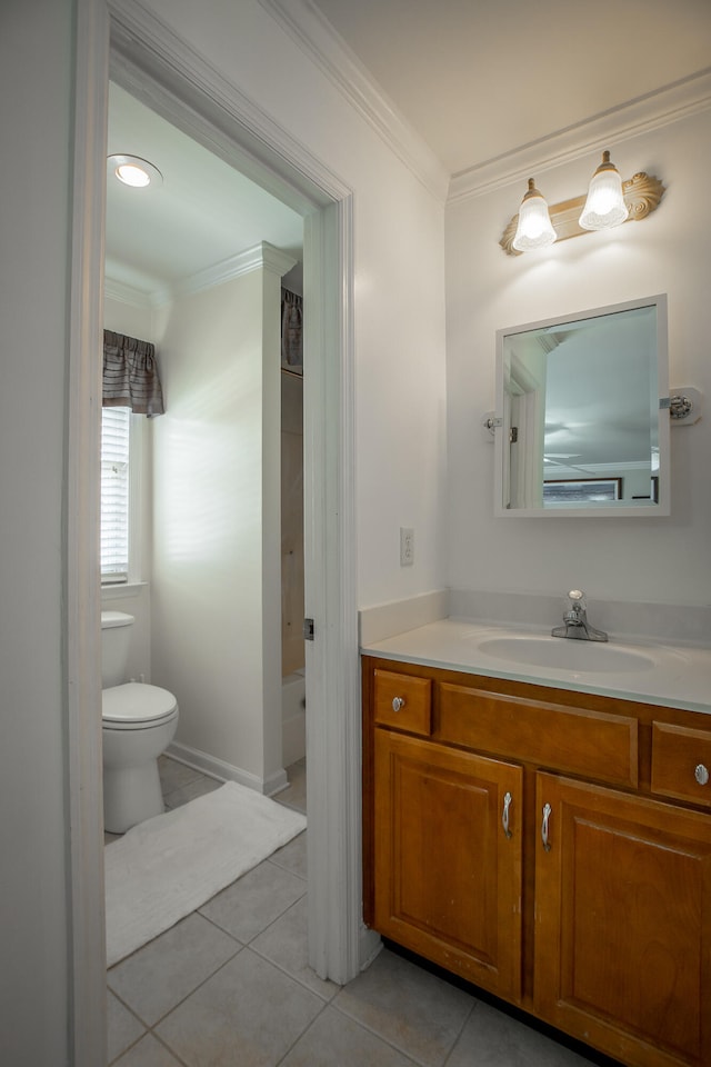 bathroom with tile patterned floors, crown molding, vanity, and toilet