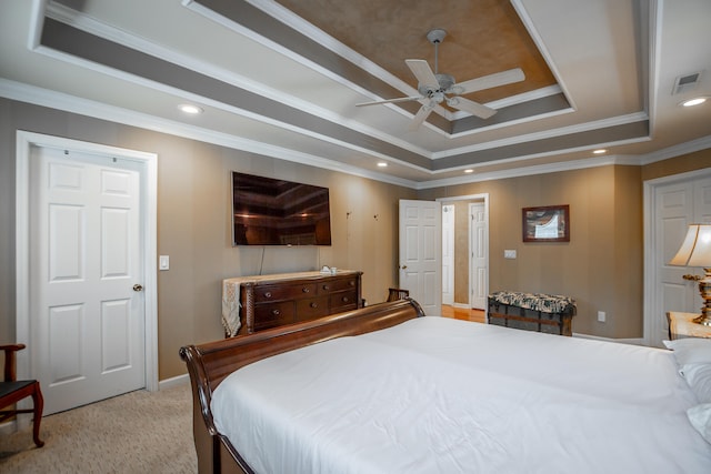 bedroom featuring light colored carpet, crown molding, ceiling fan, and a tray ceiling