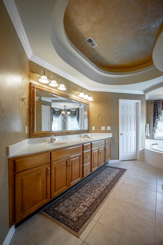 bathroom featuring vanity, a tray ceiling, tile patterned floors, and crown molding