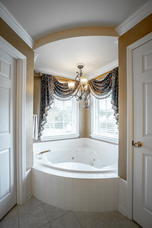 bathroom featuring tile patterned floors, tiled bath, ornamental molding, and an inviting chandelier