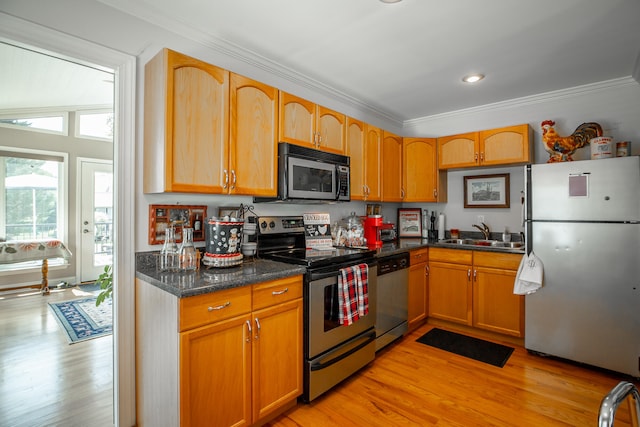 kitchen featuring sink, stainless steel appliances, light hardwood / wood-style flooring, crown molding, and dark stone counters