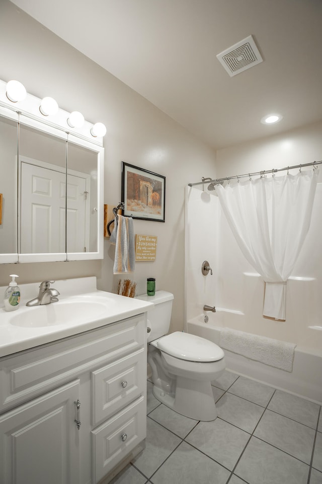 full bathroom featuring tile patterned flooring, vanity, toilet, and shower / bath combo with shower curtain