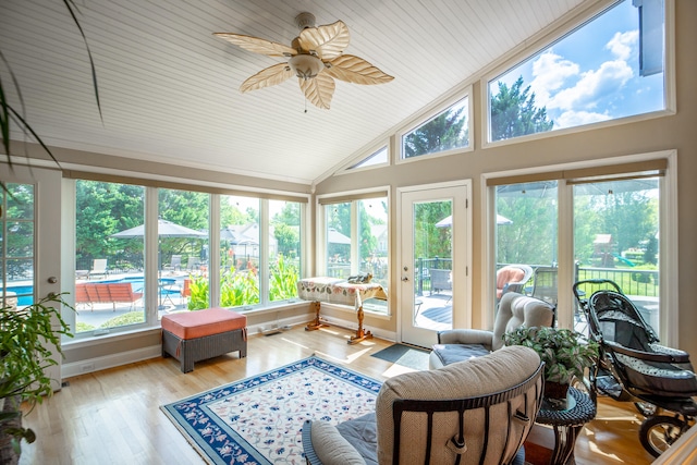 sunroom / solarium with wood ceiling, vaulted ceiling, a wealth of natural light, and ceiling fan