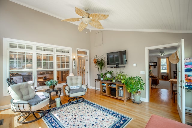 interior space featuring hardwood / wood-style floors, ceiling fan, lofted ceiling, and ornamental molding