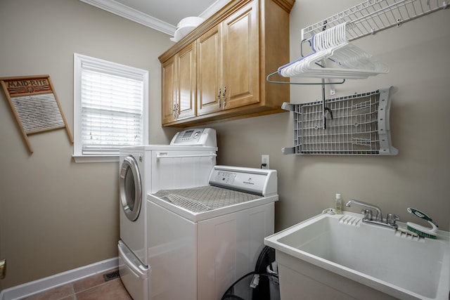 laundry room with sink, cabinets, tile patterned floors, washer and clothes dryer, and ornamental molding