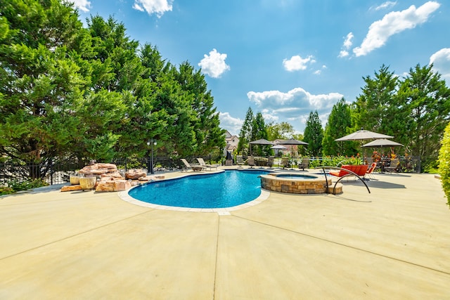 view of swimming pool with a gazebo, a patio area, and an in ground hot tub