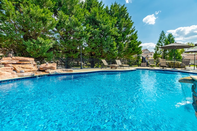 view of swimming pool with pool water feature