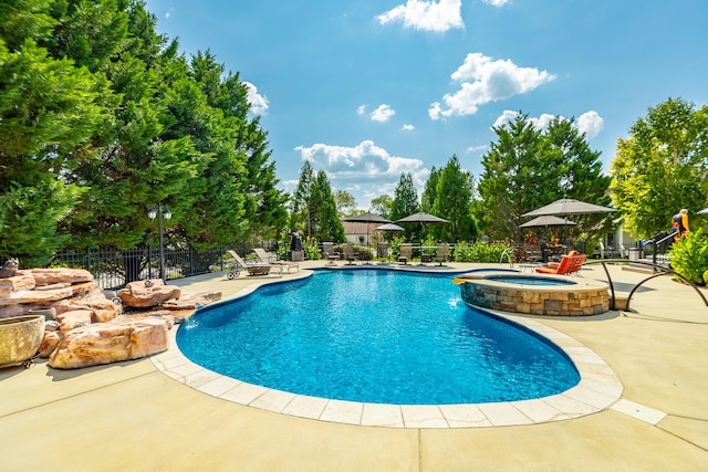 view of swimming pool featuring a patio and pool water feature