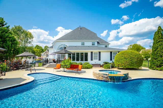 view of pool with a gazebo, an in ground hot tub, pool water feature, and a patio