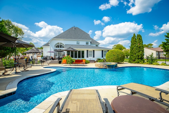 view of swimming pool featuring an in ground hot tub and a patio area