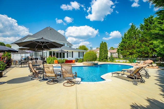 view of swimming pool featuring an in ground hot tub and a patio area