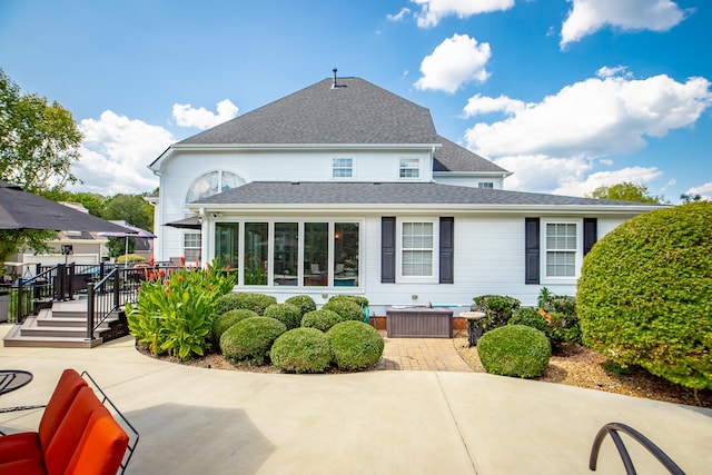 rear view of house with a patio and a wooden deck