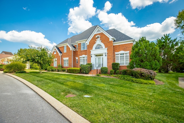 colonial-style house with a front lawn