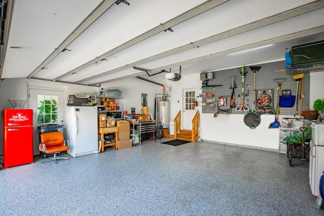 garage with water heater, white fridge, and a garage door opener