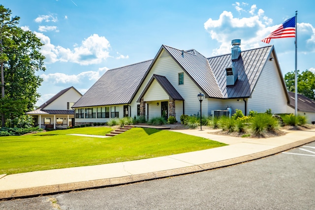 view of front of home featuring central AC and a front lawn