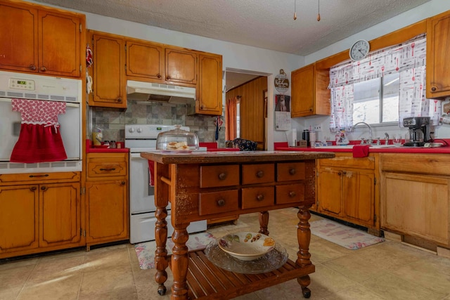 kitchen with white appliances, sink, a textured ceiling, tasteful backsplash, and light tile patterned flooring