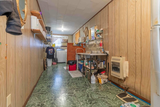 misc room with washer / clothes dryer, heating unit, and wood walls