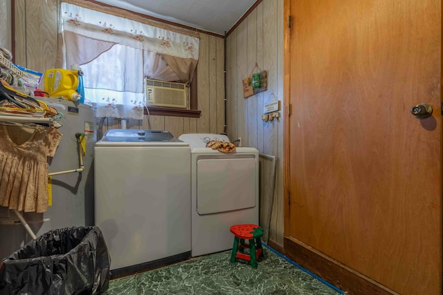 laundry room with washing machine and dryer and wooden walls