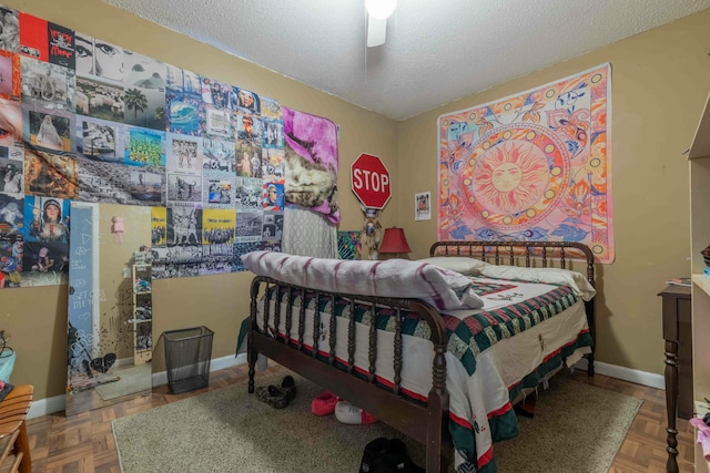 bedroom featuring ceiling fan, parquet flooring, and a textured ceiling