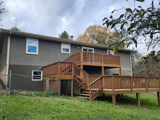 rear view of property featuring a yard and a wooden deck