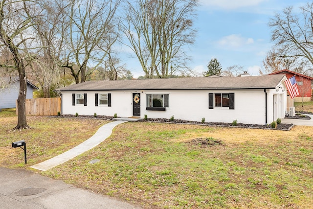 single story home with a garage and a front lawn