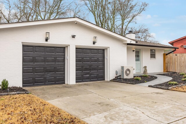 ranch-style home with ac unit and a garage