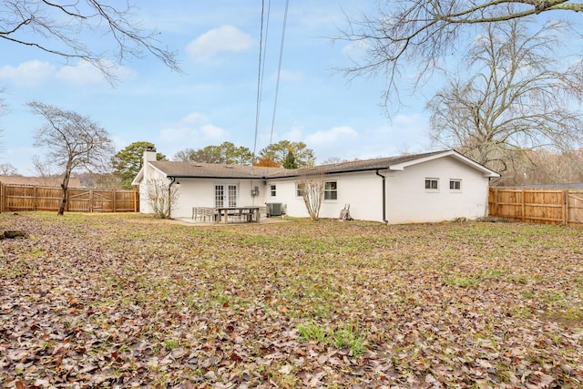 rear view of house featuring central air condition unit and a patio