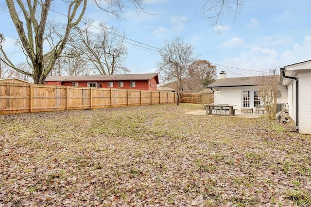 view of yard featuring french doors and a patio