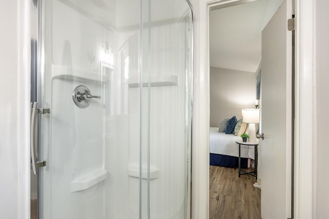 bathroom featuring hardwood / wood-style flooring and walk in shower