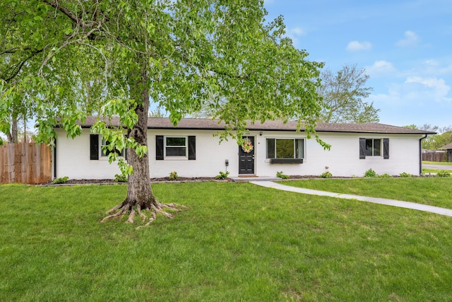 single story home with a front yard, brick siding, and fence