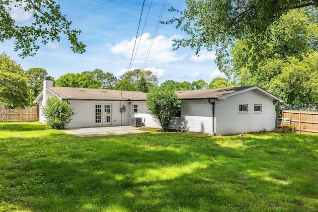 1243 Durham Dr, Chattanooga, TN 37421 - back of house featuring french doors, central AC unit, a patio, a chimney, and brick siding