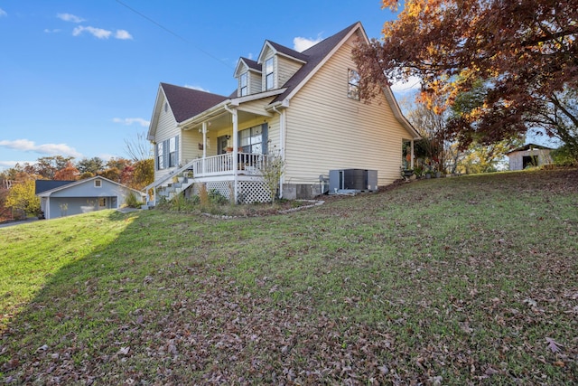 view of property exterior featuring a lawn, covered porch, and central AC