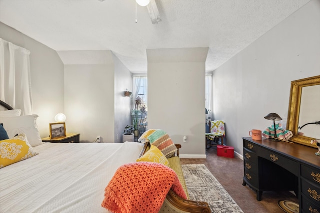 carpeted bedroom with ceiling fan and a textured ceiling