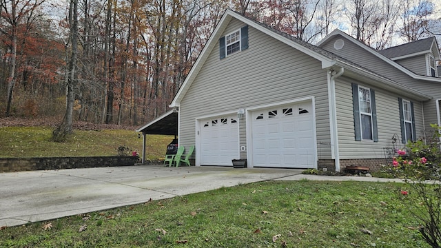 view of side of property featuring a garage and a yard